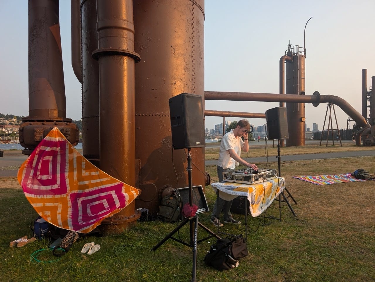 DJ setup at Gas Works Park with the old refinery towers at sunset